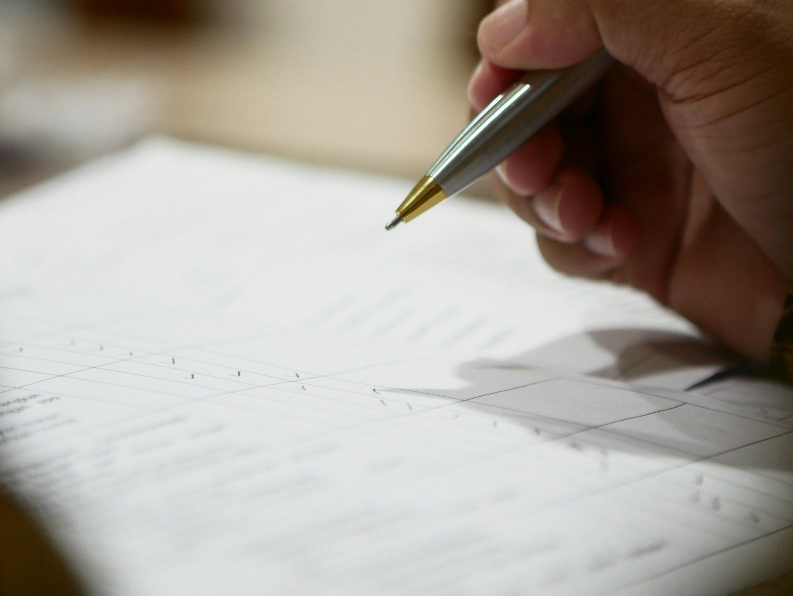 Person reviewing legal documents with a pen, illustrating settlement agreement advice, employment settlement negotiations and independent legal advice from Pre-Law.