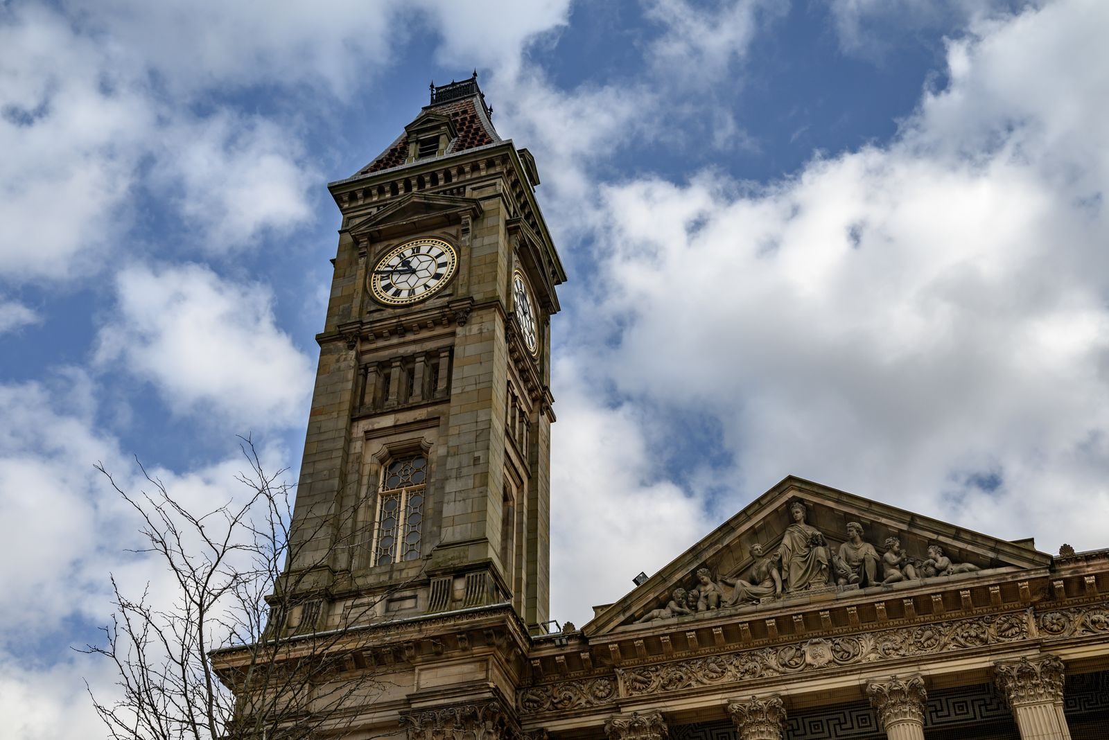 Historic Bolton Town Hall clock tower against a cloudy sky, highlighting commercial law, business legal advice and access to a qualified solicitor in Bolton through Pre-Law.